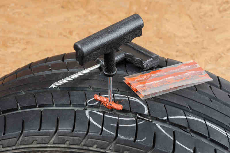 A punctured tubeless tyre being repaired